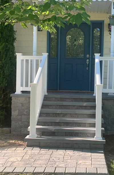 After: new white railings on both sides of the steps and across the landing